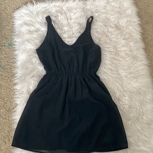 H&M, size 8. Black dress with stretchy waist band and lined.